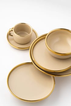 A Set of light brown ceramic plate and cup on a white background
