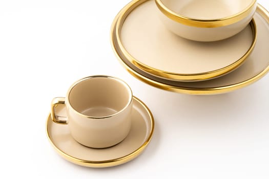 A Set of light brown ceramic plate and cup on a white background