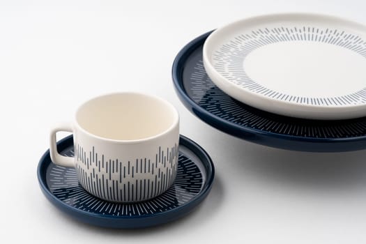 A set of blue and white luxury ceramic kitchen utensils on a white background