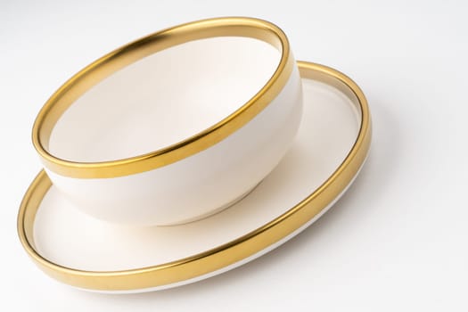 A set of white and brown ceramic plate and cup on a white background