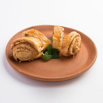 A beautiful shot of tasty sweet rolls with walnuts, raisins and sugar