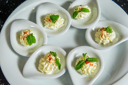 A top view of a set of plates with sour cream with mint