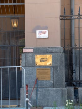 Wrapped around flagpole flag of the USA in Russia Moscow.