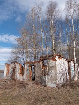 Burnt wooden country house with a brick pipe.
