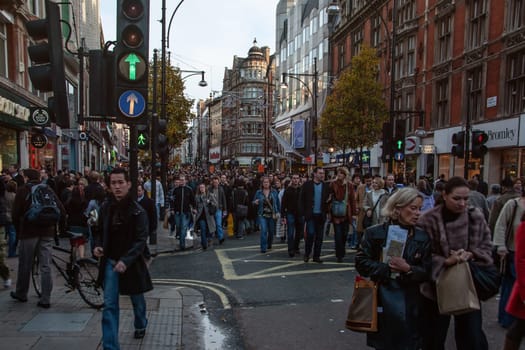 London, United Kingdom - December 2nd, 2006: Tens of thousands pedestrians walking on otherwise very busy road during "Oxford Street closed for traffic" event.Plans are to pedestrianise it permanently