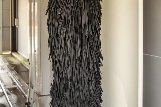 Black rotating brush in carwash