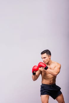 Professional athlete boxer in red gloves isolated on studio. Sport, competition concept.