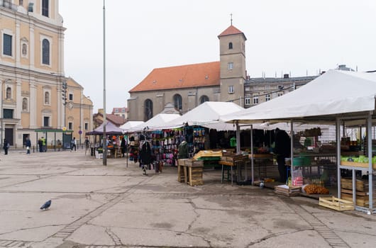 Poznan, Poland - January 20, 2023: Small market on the square near the church.