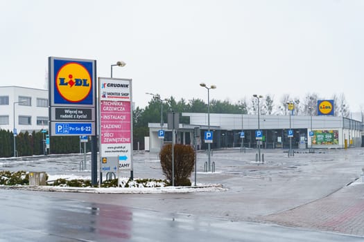 Poznan, Poland - January 22, 2023: Empty parking lot in front of Lidl store. The supermarket is closed, Sunday.