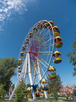 Atraktsion colorful ferris wheel against the sky.