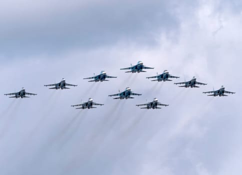 MOSCOW, RUSSIA - MAY 7, 2021: Avia parade in Moscow. su-35 and su-34 and su-30 in the sky on parade of Victory in World War II in Moscow, Russia