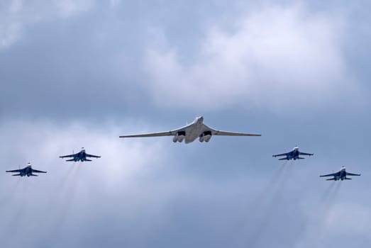 MOSCOW, RUSSIA - MAY 7, 2021: Avia parade in Moscow. su-35 and strategic bomber and missile platform Tu-160 in the sky on parade of Victory in World War II in Moscow, Russia