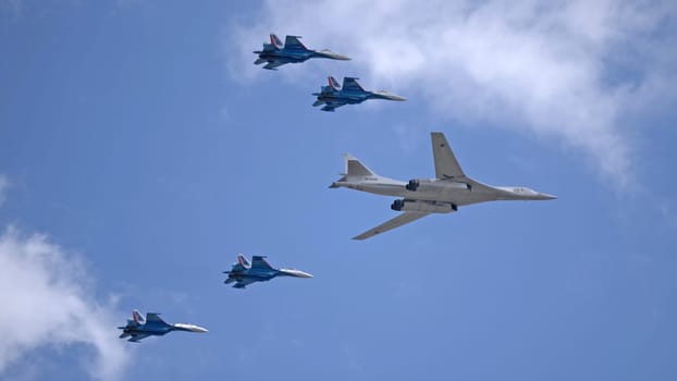 MOSCOW, RUSSIA - MAY 7, 2021: Avia parade in Moscow. su-35 and strategic bomber and missile platform Tu-160 in the sky on parade of Victory in World War II in Moscow, Russia