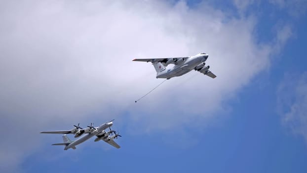 MOSCOW, RUSSIA - MAY 7, 2021: Avia parade in Moscow. tanker Ilyushin Il-78 and strategic bomber and missile platform Tu-95 in the sky on parade of Victory in World War II in Moscow, Russia