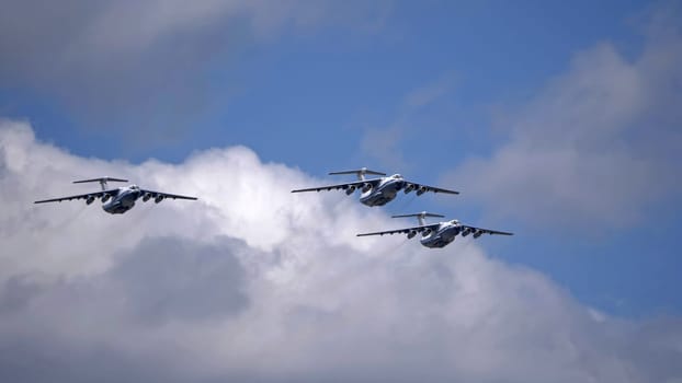 MOSCOW, RUSSIA - MAY 7, 2021: Avia parade in Moscow. 3 Ilyushin Il-76 multi-purpose four-engined strategic airlifters fly in the sky on parade of Victory in World War II in Moscow, Russia