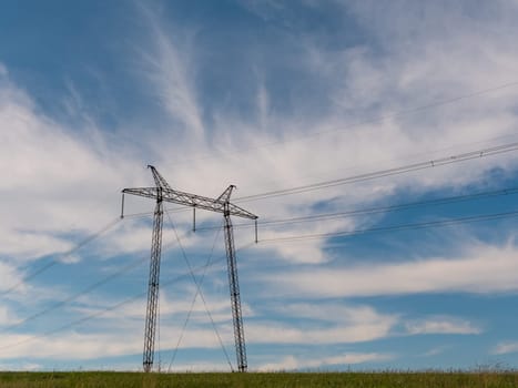 cloudy morning sky and a high-voltage line.