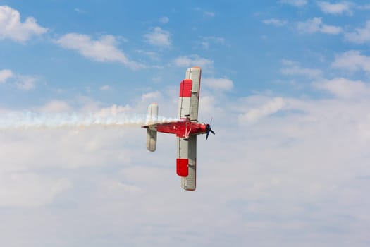 Aircraft AN-2 in a turn against the sky with clouds.