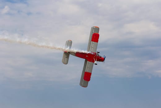 Aircraft AN-2 in a turn against the sky with clouds.