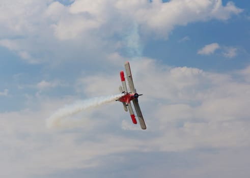 Aircraft AN-2 in a turn against the sky with clouds.