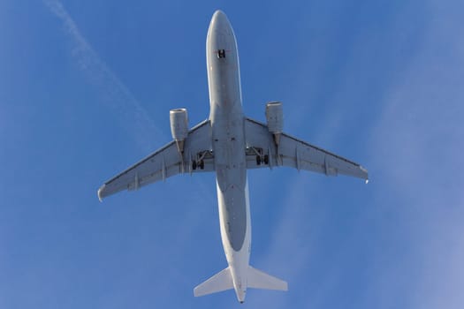 Airplane flies against a background of white clouds