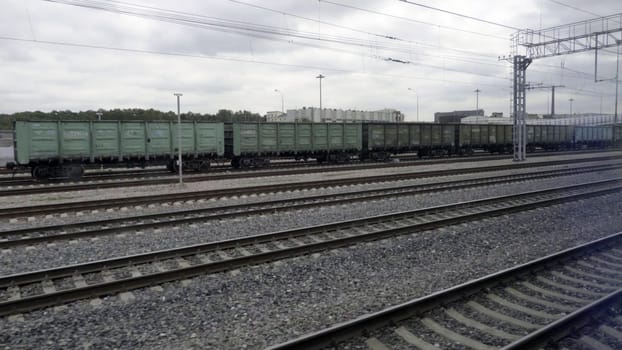 View of the railway rails and sleepers running outside the train window.