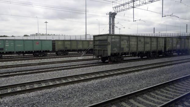 View of the railway rails and sleepers running outside the train window.