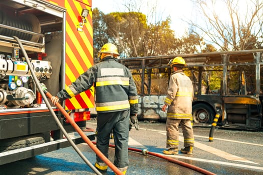 Rescue Team of Firefighters Arrive on the Car Crash fired passenger bus Traffic Accident Scene. Firemen fire department fight with fire on road. Accident disaster