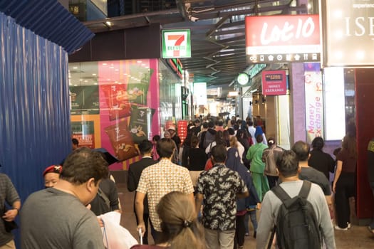 March 2, 2023. Bukit Bintang. Kuala Lumpur. People walking down the sidewalk. Street Photography.