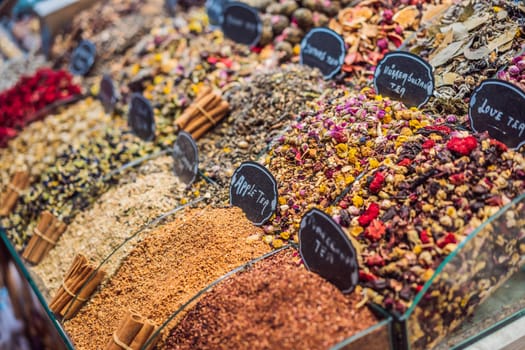 Market counter with different types of tea, herbs, plants, and dried flowers.