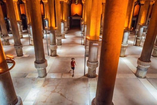 boy tourist enjoying Beautiful cistern in Istanbul. Cistern - underground water reservoir build in 6th century, Istanbul, Turkey, Turkiye.