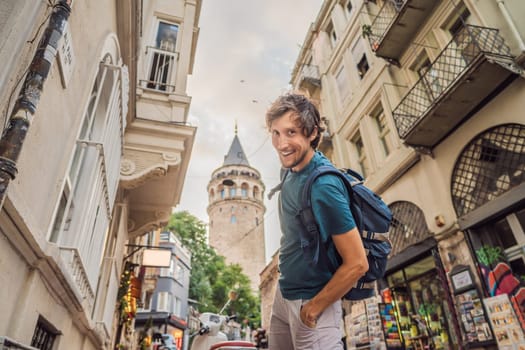 Portrait of man tourist with view of Galata tower in Beyoglu, Istanbul, Turkey. Turkiye.