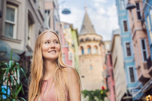 Portrait of beautiful woman tourist with view of Galata tower in Beyoglu, Istanbul, Turkey. Turkiye.