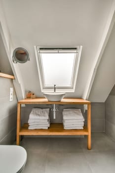 a bathroom with two towels on the shelf and a toilet in the other side of the bathtub is visible