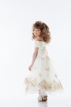 Smiling young princess posing in studio, isolated on white
