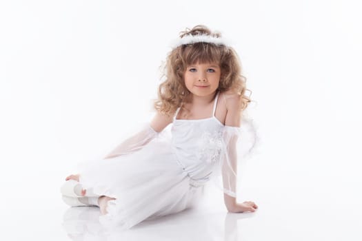 Smiling young girl posing in angel costume, isolated on white