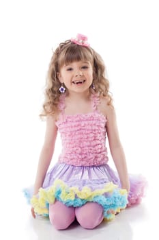 Smiling curly girl posing in candy costume, isolated on white