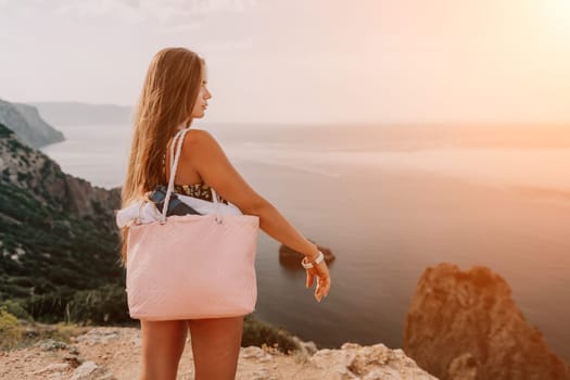 Woman travel sea. Happy tourist taking picture outdoors for memories. Woman traveler looks at the edge of the cliff on the sea bay of mountains, sharing travel adventure journey.