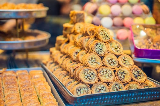 Traditional oriental sweet pastry cookies, nuts, dried fruits, pastilles, marmalade, Turkish desert with sugar, honey and pistachio, in display at a street food market.