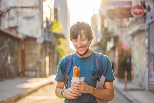 Man eating street food in Istanbul. Balik ekmek - fish in a bread, traditional Turkish fast food. Istanbul, Turkey.