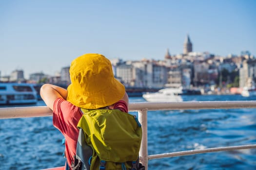 Happy boy enjoying the sea from ferry boat crossing Bosphorus in Istanbul. Summer trip to Istanbul. Traveling with kids concept.