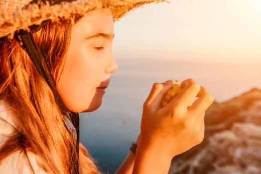 Portrait of young beautiful girl eating corn. Snacking on the sea