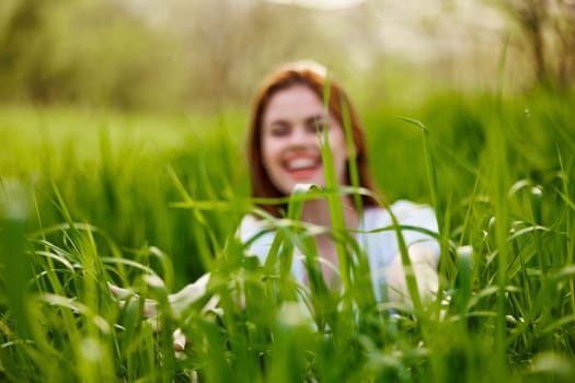 silhouette of a woman walking in tall grass. Photo out of focus. High quality photo