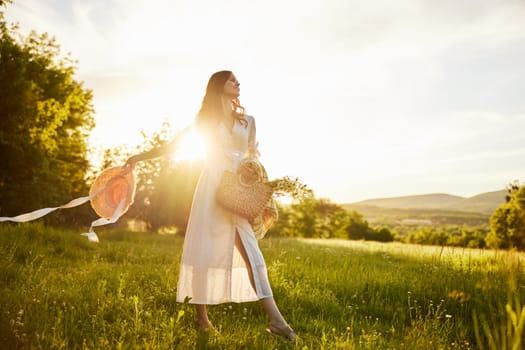 horizontal photo of a woman in a long light dress walking through the forest, illuminated from the back by the rays of the setting sun. High quality photo