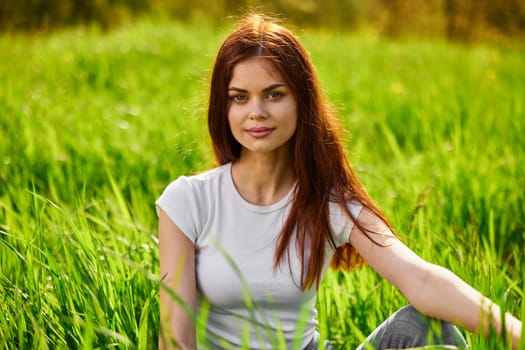 happy cheerful woman laying in green grass. High quality photo