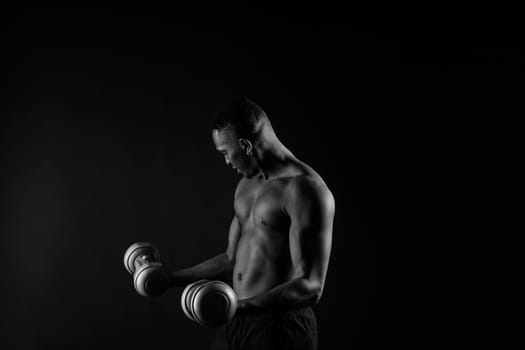 Portrait of happy african man with dumbbells over red and black background