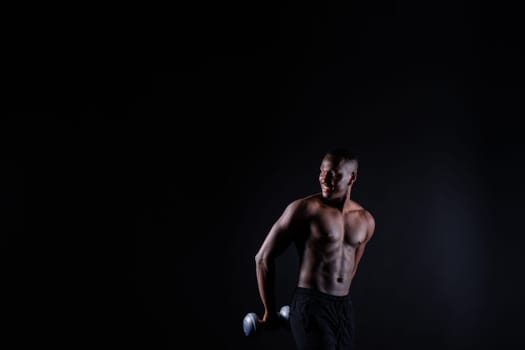 Portrait of happy african man with dumbbells over red and black background