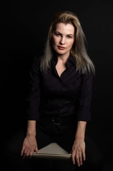 Blonde woman portrait, attractive adult girl in studio over black background