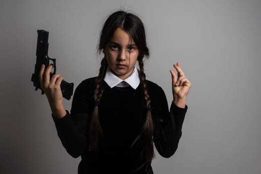 Wednesday Addams. Gothic girl with pistol, weapon.