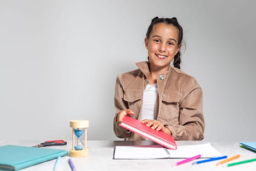 Beautiful dark-eyed dark-haired girl smiling and studying.