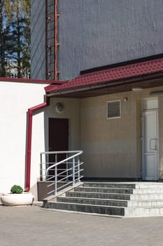 Porch with steps and building entrance close up